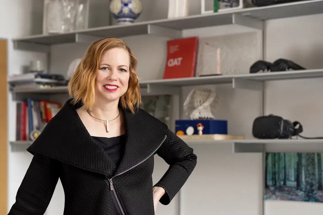 Professor Amber Bartosh standing and smiling.